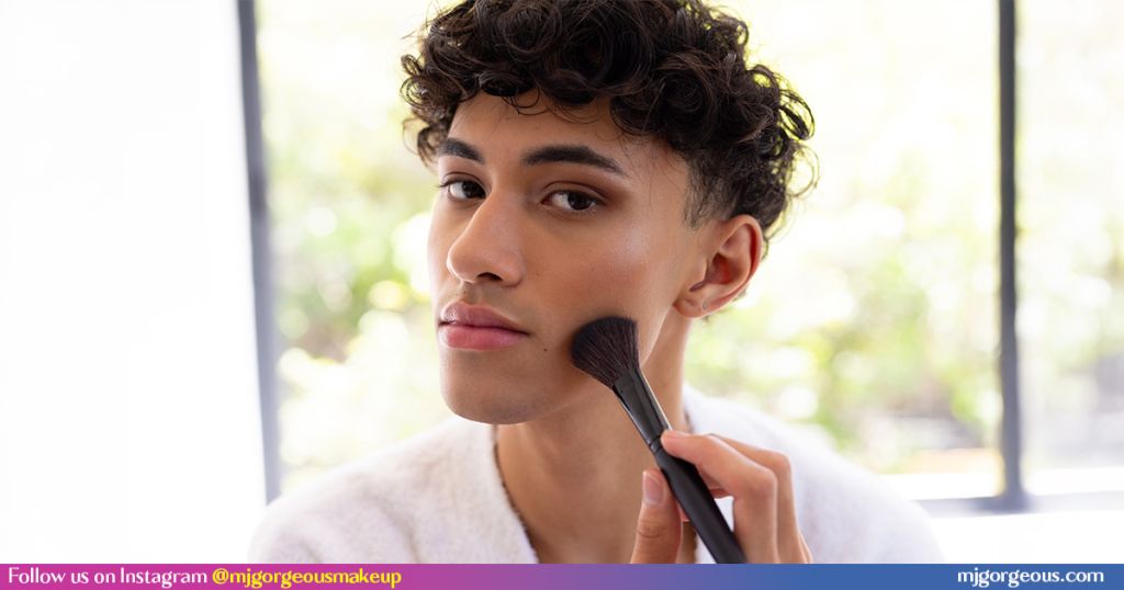 Man applying makeup with brush