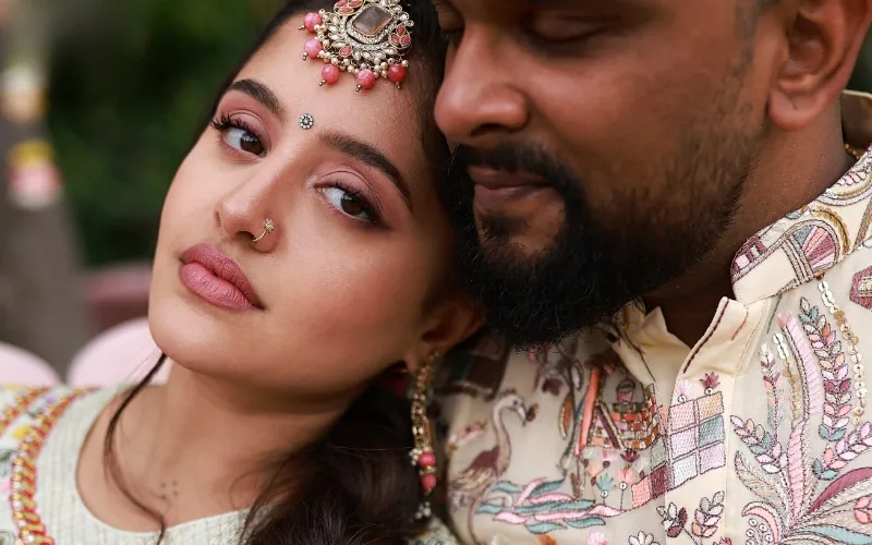 Bride with soft pink Mehendi makeup with her groom during their wedding celebration